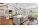 Open concept living space with exposed wood beams, a brick fireplace, and an eat-in kitchen at 30416 Saddlebag Trl, Myakka City, FL 34251