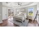 Spacious main bedroom with access to a patio, wood floors, and comfortable decor at 30416 Saddlebag Trl, Myakka City, FL 34251
