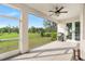 Covered patio boasts outdoor kitchen setup and overlooks a large green yard with mature trees at 30416 Saddlebag Trl, Myakka City, FL 34251