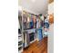 Well-organized walk-in closet featuring shelving, hanging racks, and hardwood floors at 30416 Saddlebag Trl, Myakka City, FL 34251