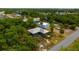Aerial view of the home and garage located on the wooded lot at 3320 Audette St, Port Charlotte, FL 33948