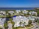 Inviting aerial view of stunning condo buildings with a pool and a peaceful pond at 3420 77Th W St # 202, Bradenton, FL 34209