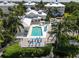 Stunning aerial view of the pool area, showcasing its ample deck space and inviting atmosphere at 3420 77Th W St # 202, Bradenton, FL 34209
