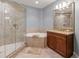 Bathroom highlighting a walk-in shower, soaking tub, and vanity with granite countertops, creating a spa-like atmosphere at 3420 77Th W St # 202, Bradenton, FL 34209