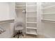 Walk-in closet featuring built-in shelving, providing ample storage space and a stylish chair for comfort at 3420 77Th W St # 202, Bradenton, FL 34209