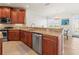A chef's kitchen with stainless steel appliances, granite countertops, and custom wood cabinetry at 3420 77Th W St # 202, Bradenton, FL 34209