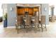 Charming kitchen bar with four woven barstools, granite countertops, and stainless steel appliances, perfect for casual dining at 3420 77Th W St # 202, Bradenton, FL 34209
