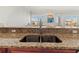 Close-up of a granite countertop and stainless sink with views from the kitchen at 3420 77Th W St # 202, Bradenton, FL 34209