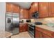 Well-equipped kitchen with stainless steel appliances and granite countertops, offering a modern cooking space at 3420 77Th W St # 202, Bradenton, FL 34209