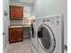 Laundry room featuring modern washer and dryer units, cabinetry, and granite countertops for convenience at 3420 77Th W St # 202, Bradenton, FL 34209