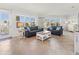A stylish living room with two couches, large windows, and a view of the outdoors at 3420 77Th W St # 202, Bradenton, FL 34209