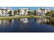 Peaceful pond view with fountain, showcasing the condo buildings in the community at 3420 77Th W St # 202, Bradenton, FL 34209