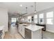 Open-concept kitchen with a large island, stainless steel appliances, and views of the living area and pool at 3619 Quiet Dr, Sarasota, FL 34240