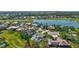 Serene aerial view of a home nestled in a golf course community with a tranquil lake at 3725 Spyglass Hill Rd, Sarasota, FL 34238