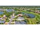 Picturesque aerial view of the home, showcasing the screened pool, golf course frontage, and neighborhood lake at 3725 Spyglass Hill Rd, Sarasota, FL 34238
