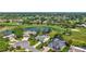 Stunning aerial view of a home on a golf course with mature trees and a serene lake at 3725 Spyglass Hill Rd, Sarasota, FL 34238