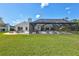 Expansive backyard with a paver patio, fire pit, screened pool area, and well-maintained lawn for outdoor enjoyment at 3725 Spyglass Hill Rd, Sarasota, FL 34238