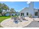 A spacious backyard with an outdoor fire pit area and manicured lawn at 3725 Spyglass Hill Rd, Sarasota, FL 34238