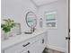 Stylish bathroom featuring a modern vanity, elegant mirror, and a bright, airy window at 3725 Spyglass Hill Rd, Sarasota, FL 34238