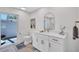 Bathroom featuring a modern vanity, stylish mirror, and toilet, illuminated by natural light from a nearby window at 3725 Spyglass Hill Rd, Sarasota, FL 34238