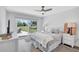 Relaxing bedroom with natural light from sliding glass doors offering views of the lawn at 3725 Spyglass Hill Rd, Sarasota, FL 34238
