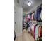 Well-organized walk-in closet with ample hanging space and shelving for efficient storage solutions at 3725 Spyglass Hill Rd, Sarasota, FL 34238