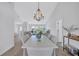 Dining room with a long white table, pendant lighting, and open-concept design at 3725 Spyglass Hill Rd, Sarasota, FL 34238