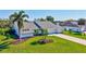 Charming single-story home featuring a well-manicured lawn, brick driveway, and inviting curb appeal at 3725 Spyglass Hill Rd, Sarasota, FL 34238