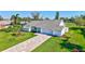 Attractive single-story home boasts a lush lawn, brick driveway, and fresh landscaping at 3725 Spyglass Hill Rd, Sarasota, FL 34238