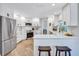 Updated kitchen with white cabinets, stainless appliances, quartz countertops and hardwood floors at 3725 Spyglass Hill Rd, Sarasota, FL 34238