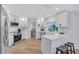 Bright kitchen with white cabinetry, stainless steel appliances, and an island with bar stool seating at 3725 Spyglass Hill Rd, Sarasota, FL 34238