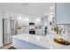 Renovated kitchen with stainless appliances, white cabinetry and island with marble countertops at 3725 Spyglass Hill Rd, Sarasota, FL 34238