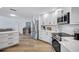 Bright kitchen with stainless steel appliances, white cabinets, and gorgeous hardwood floors at 3725 Spyglass Hill Rd, Sarasota, FL 34238