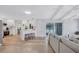 Open kitchen with stainless steel appliances, white cabinetry, and access to the living room at 3725 Spyglass Hill Rd, Sarasota, FL 34238