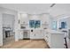 Bright kitchen with stainless appliances, white cabinets, modern fixtures and a view to the backyard at 3725 Spyglass Hill Rd, Sarasota, FL 34238