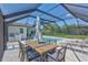Outdoor dining and lounge area featuring a spacious patio with a screened-in pool and relaxing seating at 3725 Spyglass Hill Rd, Sarasota, FL 34238