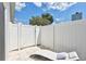 Secluded patio featuring a chaise lounge and gated fence, providing a tranquil and private outdoor space at 3725 Spyglass Hill Rd, Sarasota, FL 34238
