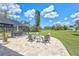 Charming patio area with comfortable seating around a fire pit overlooking the lush backyard at 3725 Spyglass Hill Rd, Sarasota, FL 34238