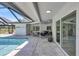 Covered patio with comfortable seating area and view of the pool at 3725 Spyglass Hill Rd, Sarasota, FL 34238