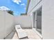 Cozy patio with a lounge chair, sliding door access, and fenced privacy, offering a private outdoor escape at 3725 Spyglass Hill Rd, Sarasota, FL 34238