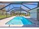 Relaxing screened pool area with lounge chairs and outdoor dining set overlooking lush green scenery at 3725 Spyglass Hill Rd, Sarasota, FL 34238