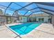 A luxurious covered pool area with a pool and lounge area at 3725 Spyglass Hill Rd, Sarasota, FL 34238