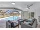 Relaxing lanai area with ample seating, a fire pit table, and scenic views of the pool and yard at 3725 Spyglass Hill Rd, Sarasota, FL 34238