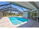 Screened-in pool area with lounge chairs and covered patio, perfect for outdoor living at 3725 Spyglass Hill Rd, Sarasota, FL 34238