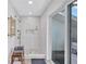Tiled walk-in shower with a glass door, rain shower head, and convenient built-in shelving at 3725 Spyglass Hill Rd, Sarasota, FL 34238