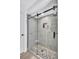 Modern tiled shower featuring glass enclosure with stone floor, providing a luxurious and spa-like experience at 3725 Spyglass Hill Rd, Sarasota, FL 34238