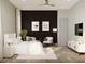 Well-lit bedroom features a king bed, modern decor, and a dark accent wall at 3811 30Th S Ave, St Petersburg, FL 33711