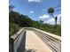 Scenic boardwalk view showcasing serene water surrounded by lush greenery and clear blue skies at 3811 30Th S Ave, St Petersburg, FL 33711
