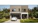 Modern two-story home featuring stone accents, a dark-colored garage door, and tropical landscaping in the front yard at 3811 30Th S Ave, St Petersburg, FL 33711