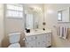 Well-lit bathroom featuring a vanity, mirror, medicine cabinet, and white toilet at 3917 Ashwood Ln # 57, Sarasota, FL 34232